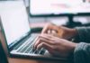 hands typing on a laptop