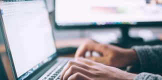 hands typing on a laptop