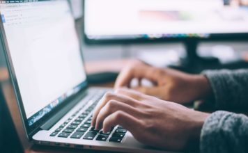 hands typing on a laptop